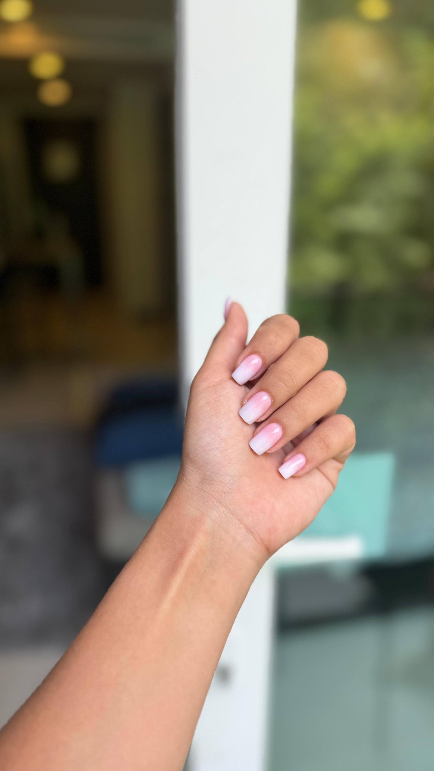 Soft pink ombré nails outdoors