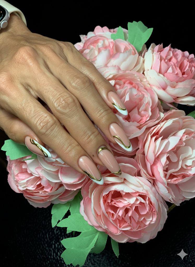 Nail art with white French tips and gold accents, surrounded by pink peonies
